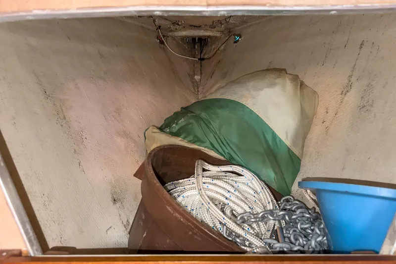 Slide: The Image of Storage area in a 1970 Morgan 42 MKI sailboat with ropes, chains, and a tarp. - 77