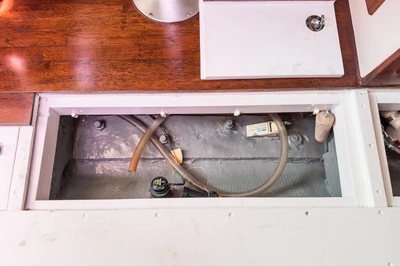 Slide: The Image of Interior view of a 1970 Morgan 42 MKI sailboat showing storage compartment and wooden cabinetry. - 78