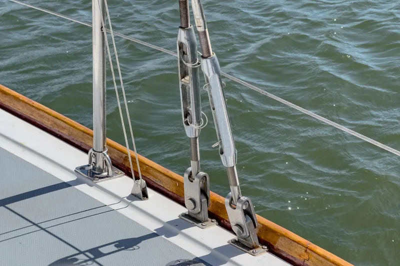 Slide: The Image of Close-up of rigging on a 1970 Morgan 42 MKI sailboat, with water in the background. - 87