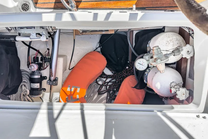 Slide: The Image of Storage compartment of a 1970 Morgan 42 MKI sailboat with safety equipment. - 88