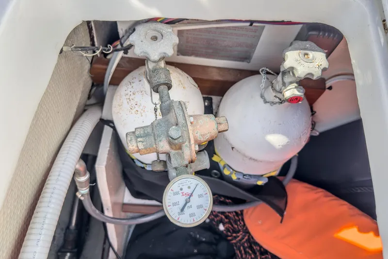 Slide: The Image of Propane tanks and gauge in a 1970 Morgan 42 MKI sailboat compartment. - 89