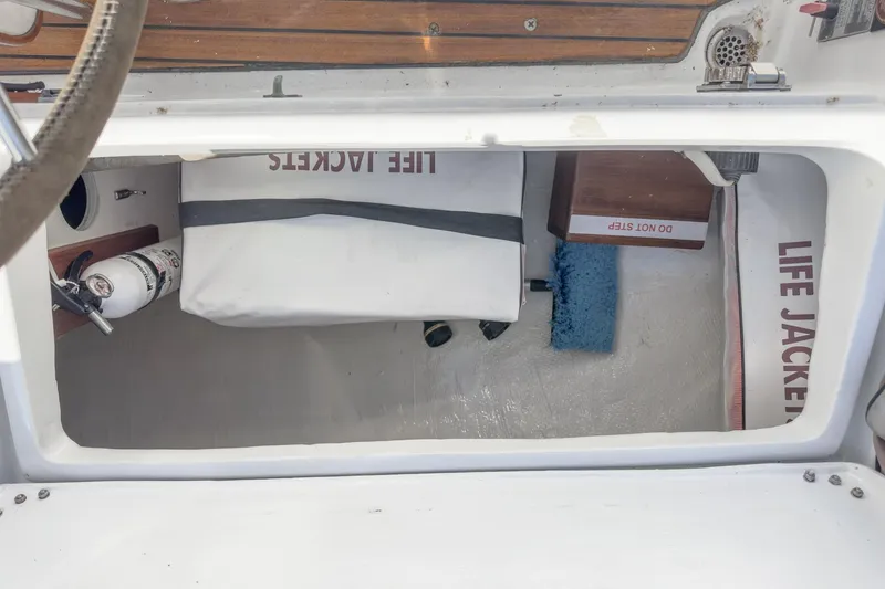Slide: The Image of Storage compartment of a 1970 Morgan 42 MKI with life jackets and fire extinguisher. - 90