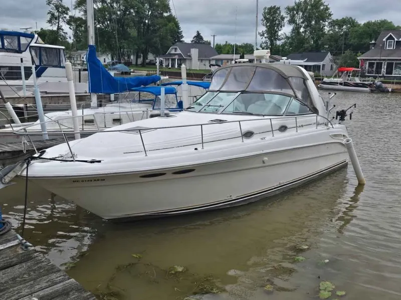 Slide: The Image of 1999 Sea Ray 340 Sundancer boat docked in harbor. - 2