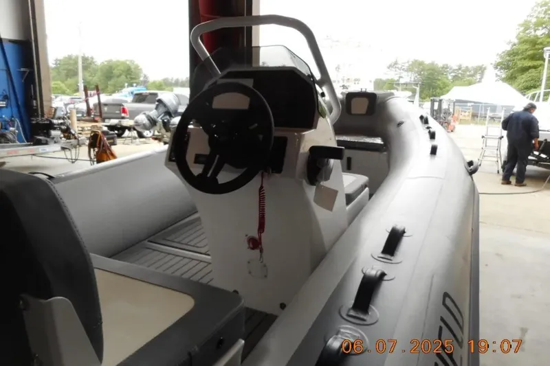 Slide: The Image of 2025 Highfield Classic 420 boat interior with steering wheel in a workshop setting. - 7