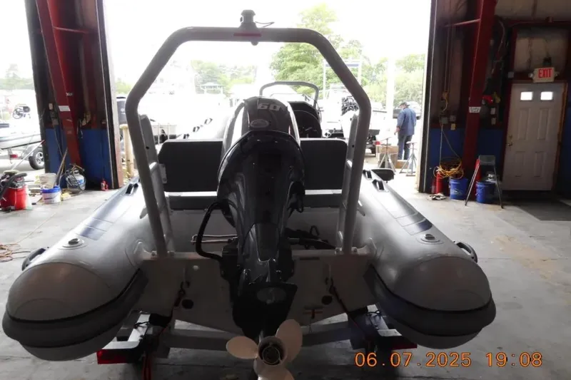 Slide: The Image of Highfield Classic 420 boat, 2025 model, in a garage with an outboard motor. - 8
