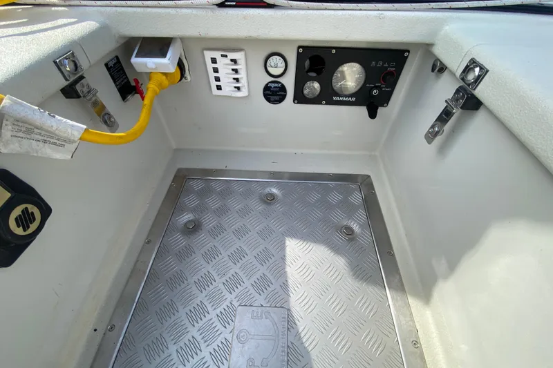 Slide: The Image of Control panel and flooring of a 2013 Devlin Onyx boat, featuring gauges and switches. - 10
