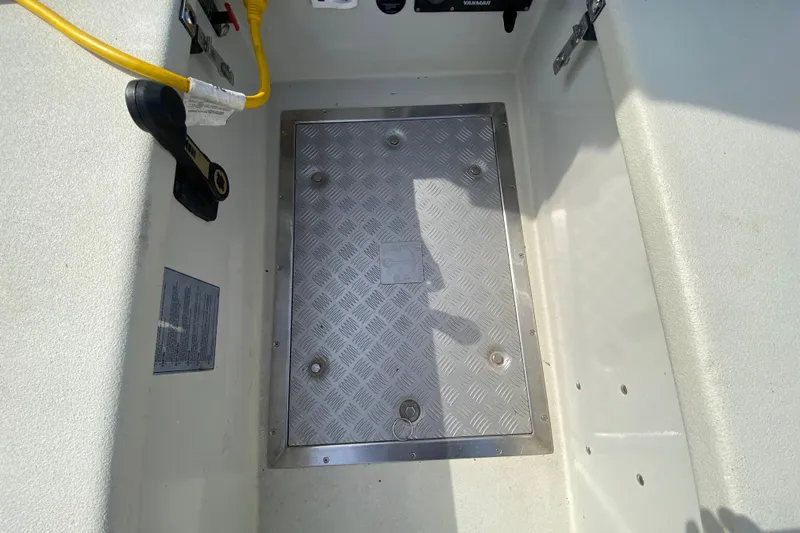 Slide: The Image of Aluminum hatch on 2013 Devlin Onyx boat deck with visible wiring and controls. - 11