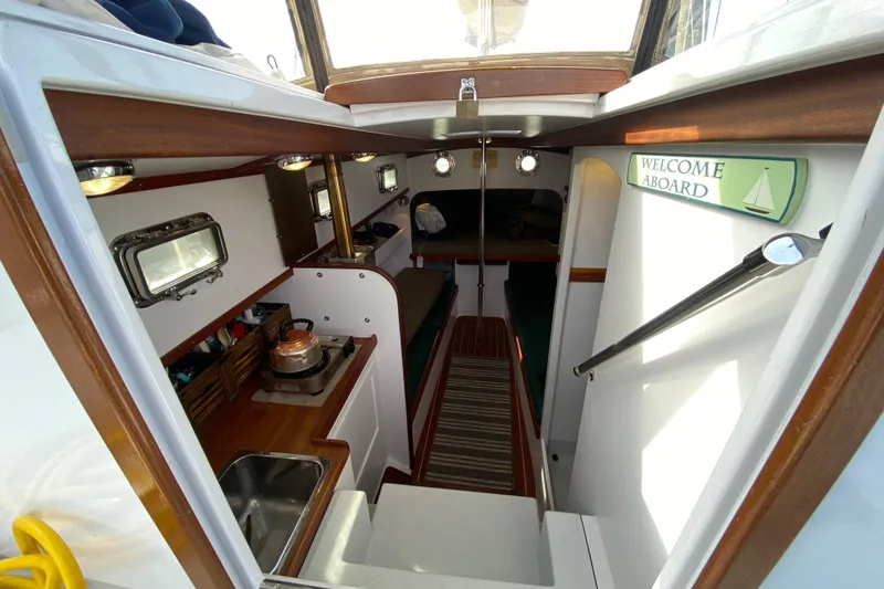 Slide: The Image of Interior of 2013 Devlin Onyx boat with cozy cabin and kitchenette. - 12