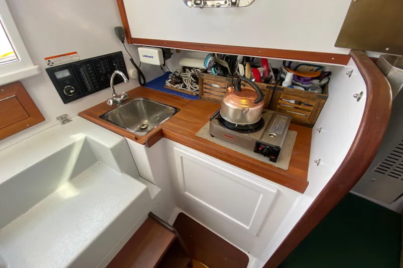 Slide: The Image of Compact kitchen area in a 2013 Devlin Onyx boat with sink and stove. - 16