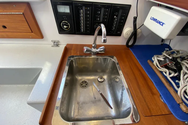 Slide: The Image of Stainless steel sink on Devlin Onyx 2013 boat with faucet and control panel. - 17