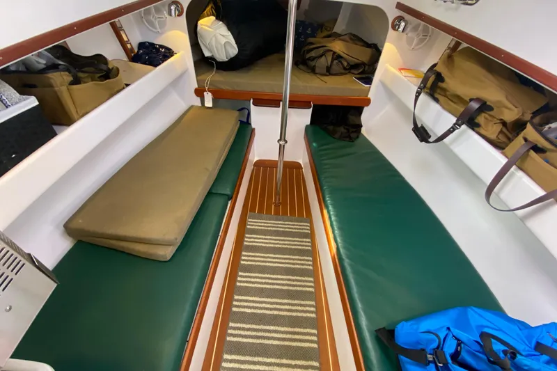 Slide: The Image of Interior of 2013 Devlin Onyx boat with green cushions and storage bags. - 18