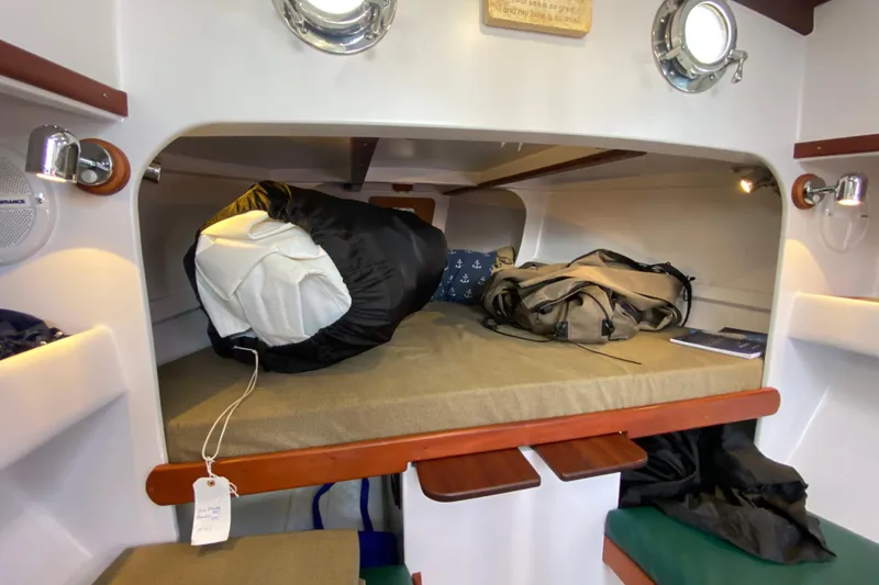 Slide: The Image of Cozy cabin interior of 2013 Devlin Onyx boat with bed and nautical decor. - 21