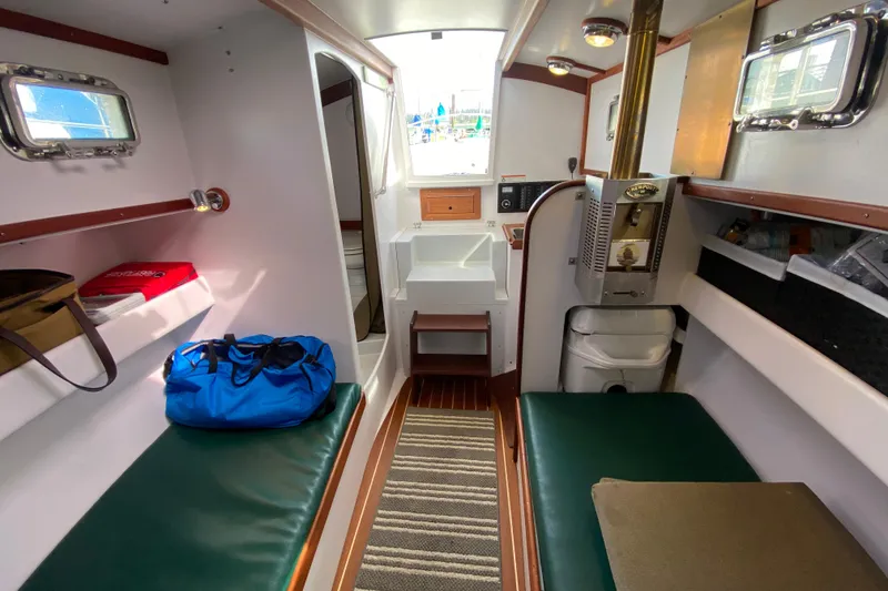 Slide: The Image of Interior of 2013 Devlin Onyx boat with seating, storage, and compact amenities. - 24