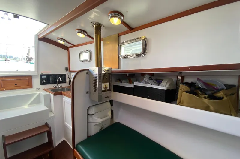 Slide: The Image of Interior of 2013 Devlin Onyx boat with kitchenette and seating area. - 25