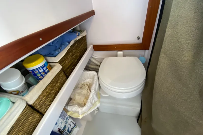 Slide: The Image of Compact bathroom in 2013 Devlin Onyx boat with storage baskets and toilet. - 27