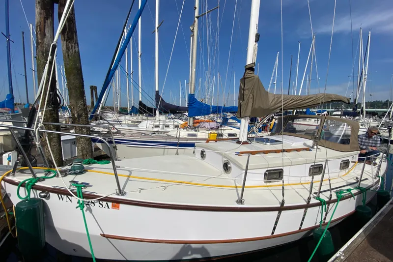 Slide: The Image of 2013 Devlin Onyx sailboat docked at marina with clear blue sky. - 3