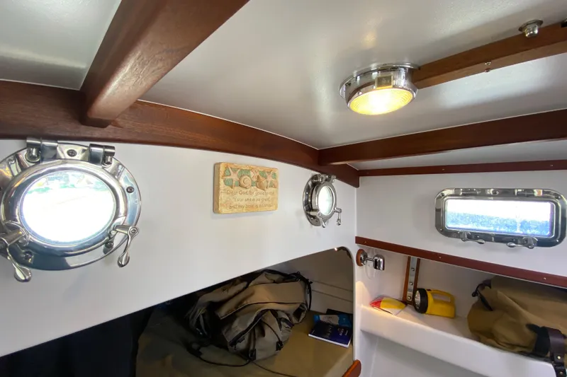 Slide: The Image of Interior of 2013 Devlin Onyx boat with portholes and wooden accents. - 30