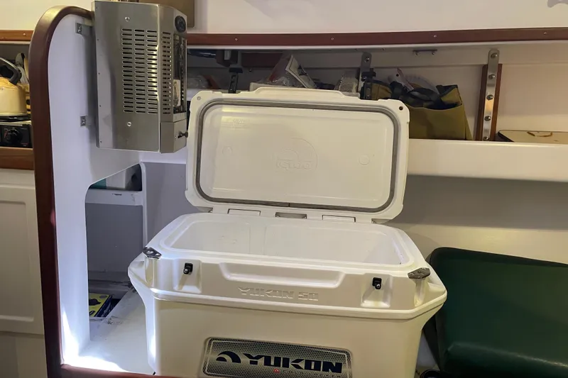 Slide: The Image of Open cooler inside a 2013 Devlin Onyx boat, showcasing storage space. - 37