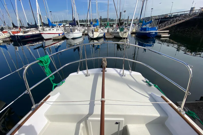 Slide: The Image of Bow view of 2013 Devlin Onyx sailboat docked in a marina with calm waters. - 7
