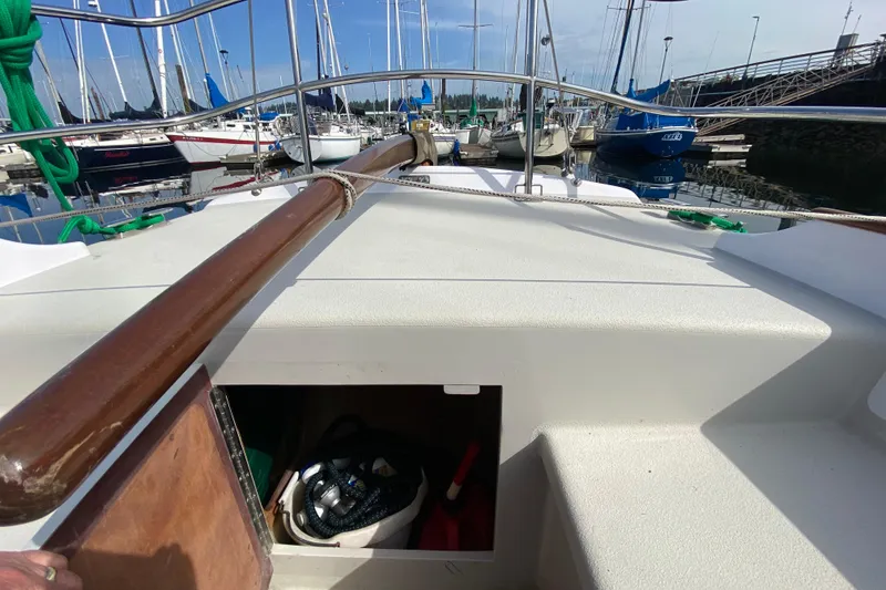 Slide: The Image of Cockpit view of 2013 Devlin Onyx sailboat docked at marina with open storage compartment. - 9