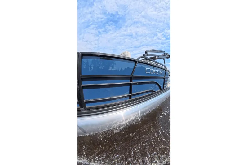 Slide: The Image of 2026 Coach 243 boat cruising on water under a clear blue sky. - 16
