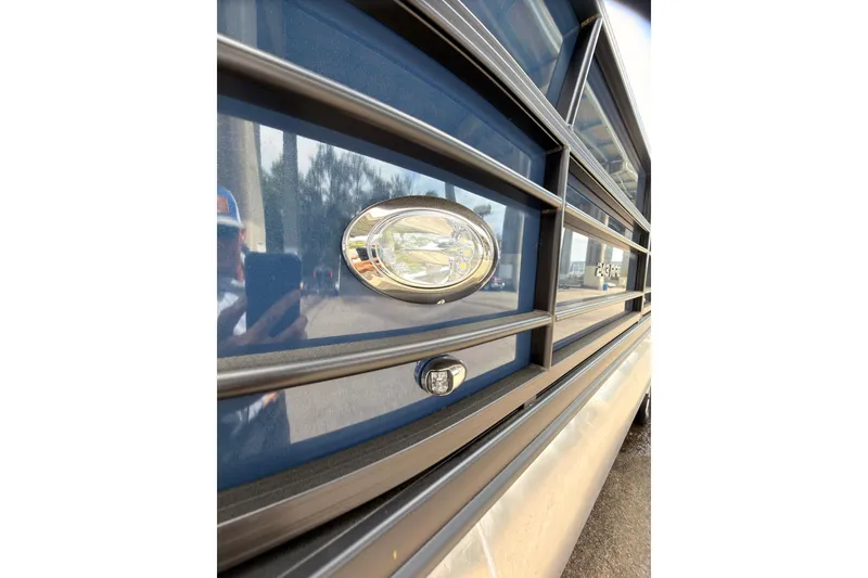 Slide: The Image of Close-up of a 2026 Coach 243 vehicle emblem on a reflective surface. - 21