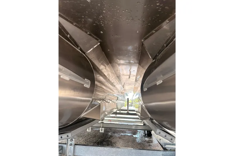 Slide: The Image of Underneath view of a 2026 Coach 243 boat hull on a trailer. - 23