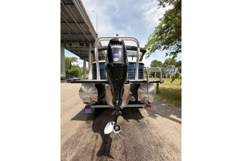 Slide: The Image of Rear view of a 2026 Coach 243 boat with a powerful outboard motor. - 6