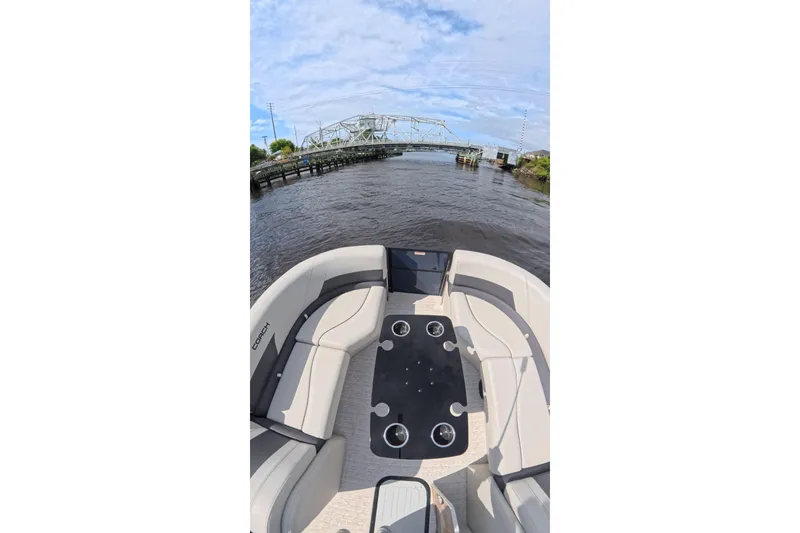 Slide: The Image of 2026 Coach 243 boat interior with seating, table, and waterway view. - 9