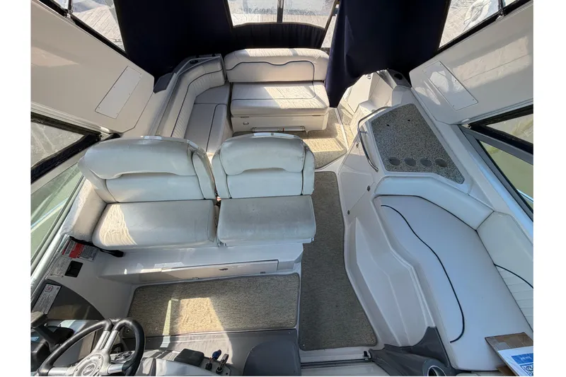 Slide: The Image of Interior of a 2007 Monterey 330 Sport Yacht with seating and helm area. - 10