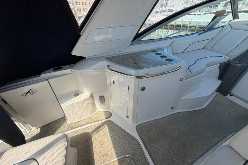 Slide: The Image of 2007 Monterey 330 Sport Yacht interior with seating and counter, dockside view. - 12
