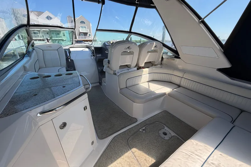 Slide: The Image of 2007 Monterey 330 Sport Yacht interior with plush seating and modern helm. - 13
