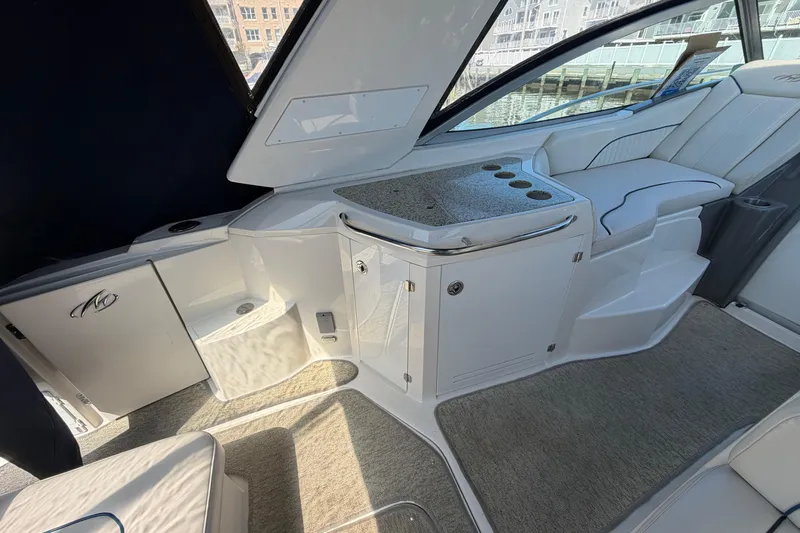 Slide: The Image of Interior of a 2007 Monterey 330 Sport Yacht with seating and storage. - 14