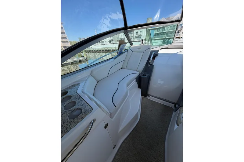 Slide: The Image of Interior view of a 2007 Monterey 330 Sport Yacht with white seating and cup holders. - 16