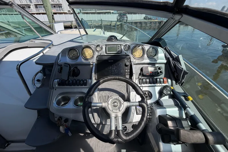 Slide: The Image of Cockpit of 2007 Monterey 330 Sport Yacht with steering wheel and control panel. - 19