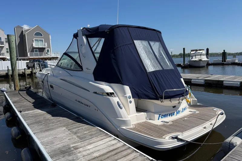 Slide: The Image of 2007 Monterey 330 Sport Yacht docked at marina, blue canopy, sunny day. - 2