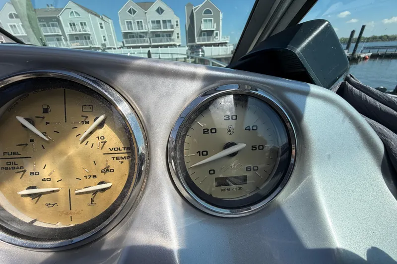 Slide: The Image of Dashboard gauges of a 2007 Monterey 330 Sport Yacht with waterfront view. - 21
