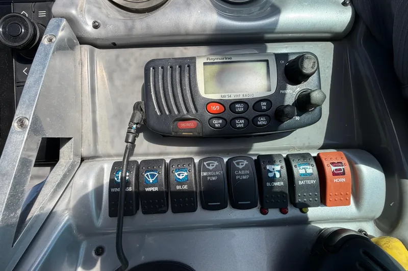 Slide: The Image of Control panel of a 2007 Monterey 330 Sport Yacht with VHF radio and switches. - 22