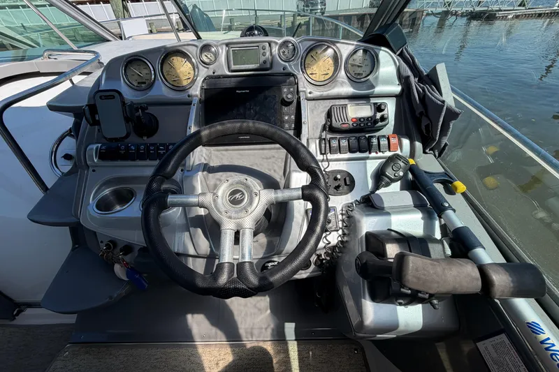 Slide: The Image of Cockpit of 2007 Monterey 330 Sport Yacht with steering wheel and control panel. - 24