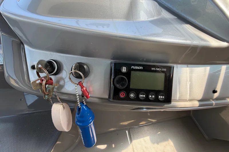 Slide: The Image of Control panel of a 2007 Monterey 330 Sport Yacht with keys and Fusion MS-NRX300 stereo. - 26