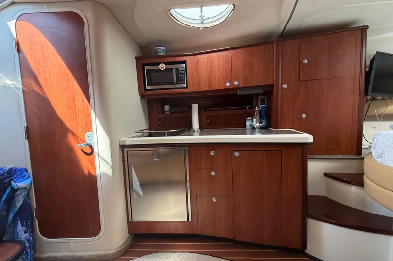 Slide: The Image of 2007 Monterey 330 Sport Yacht interior kitchen with wood cabinetry and modern appliances. - 29