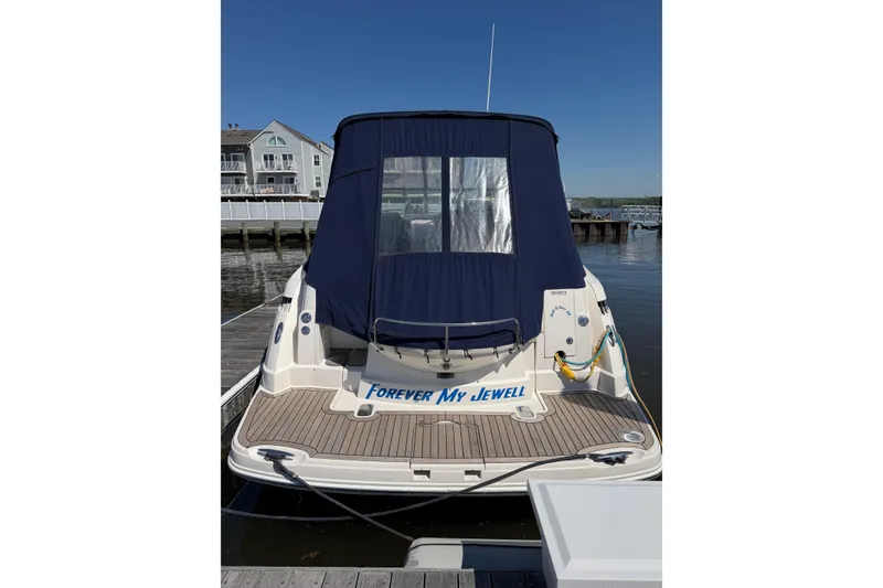 Slide: The Image of 2007 Monterey 330 Sport Yacht docked, rear view with blue cover, named "Forever My Jewell". - 3