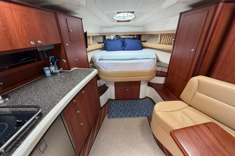 Slide: The Image of Luxurious interior of 2007 Monterey 330 Sport Yacht with bed, kitchenette, and seating area. - 30