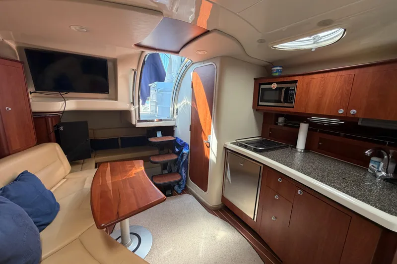 Slide: The Image of Interior of 2007 Monterey 330 Sport Yacht with kitchen, seating, and TV. - 31