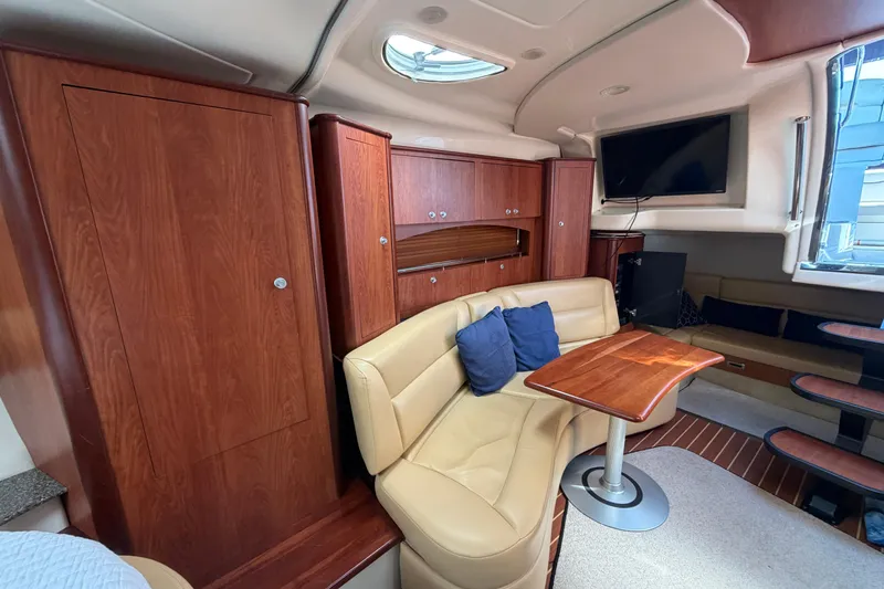 Slide: The Image of Interior of 2007 Monterey 330 Sport Yacht with wood cabinetry and beige seating. - 32