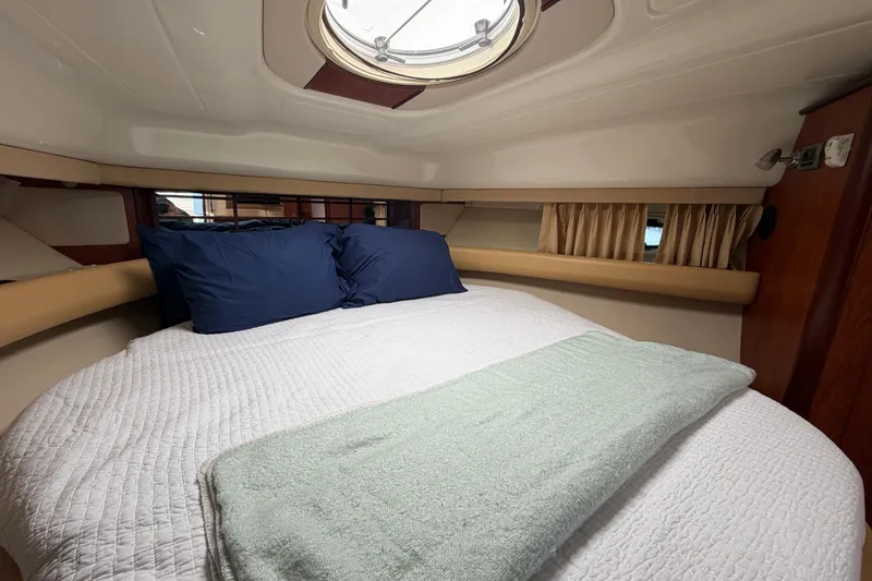 Slide: The Image of Cozy cabin interior of 2007 Monterey 330 Sport Yacht with bed and porthole. - 34