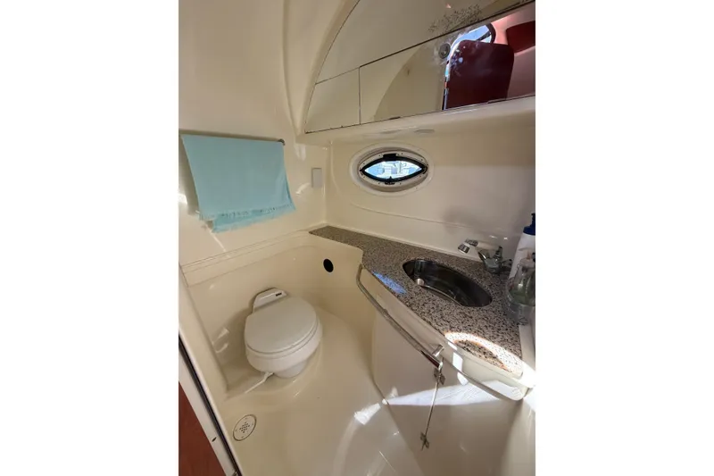 Slide: The Image of 2007 Monterey 330 Sport Yacht bathroom with toilet, sink, and oval window. - 36