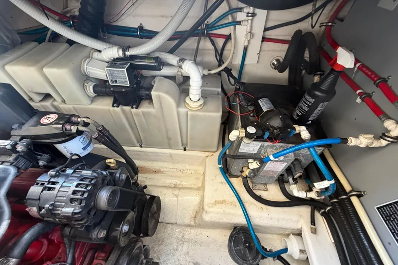 Slide: The Image of Engine compartment of a 2007 Monterey 330 Sport Yacht, showcasing mechanical components and wiring. - 38