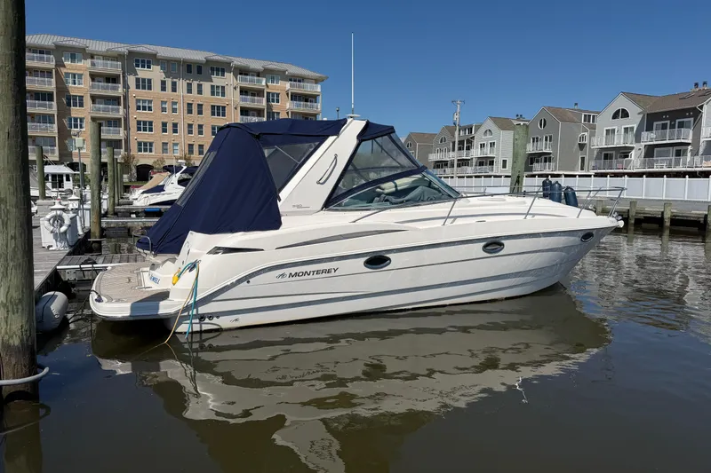Slide: The Image of 2007 Monterey 330 Sport Yacht docked at marina with waterfront buildings. - 4