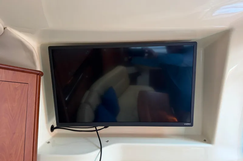Slide: The Image of Flat-screen TV mounted inside a 2007 Monterey 330 Sport Yacht cabin. - 40